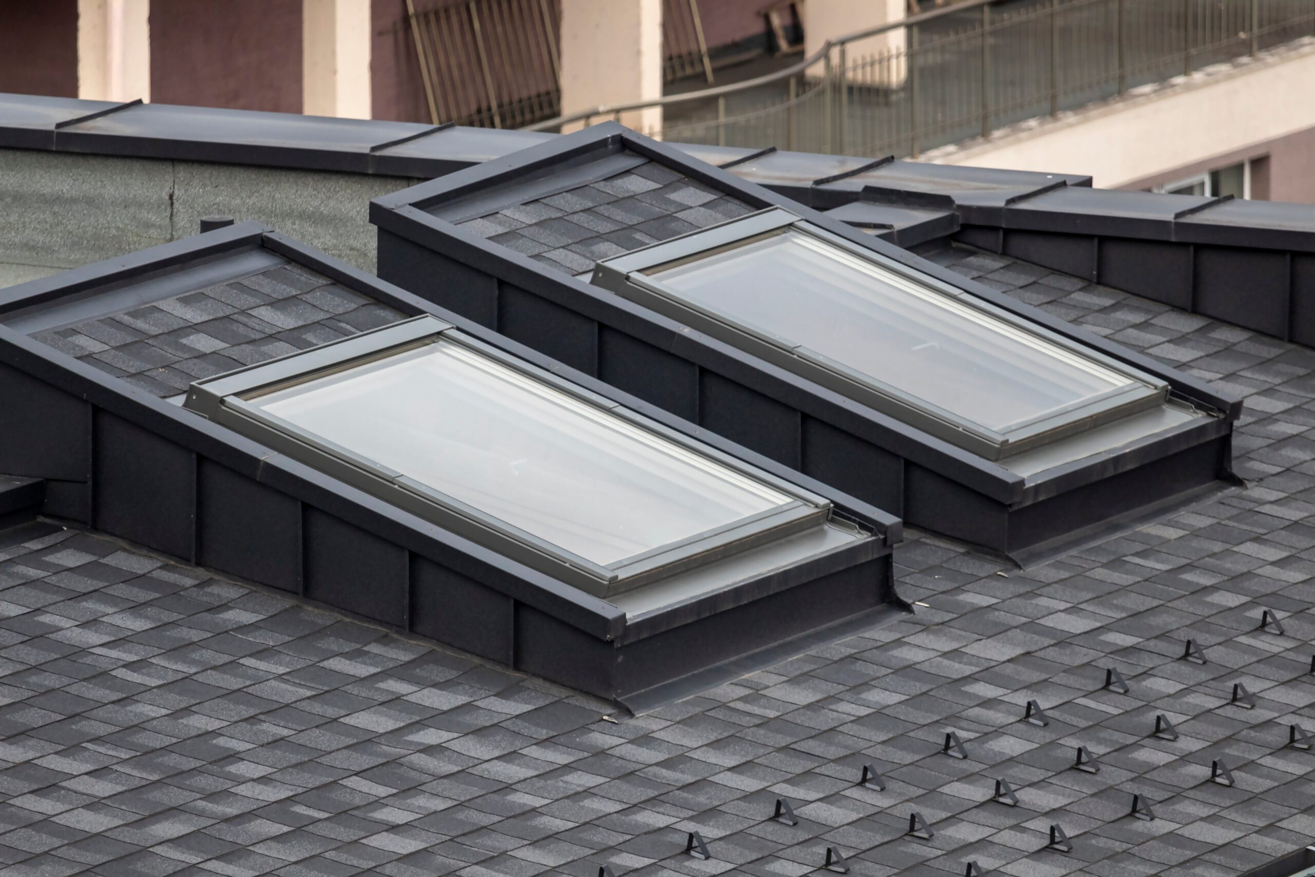 Two skylights are built into a dark gray shingled roof.
